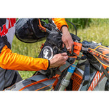 Giant Loop Fender Bag being fitted to bike headlight plastic casing