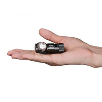Fenix Headlamp in someone's hand showing small size