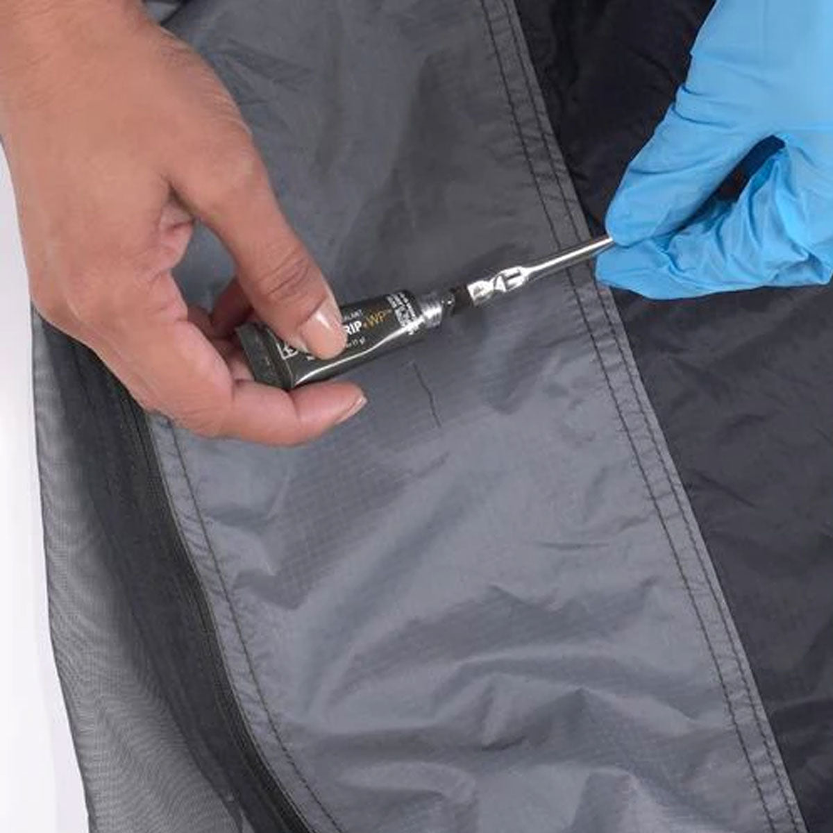 Gear Aid Seam Grip + WP Field Repair Kit in use in a repair