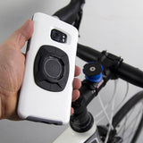 The Quad Lock Universal Adaptor on a phone about to attach to a bike