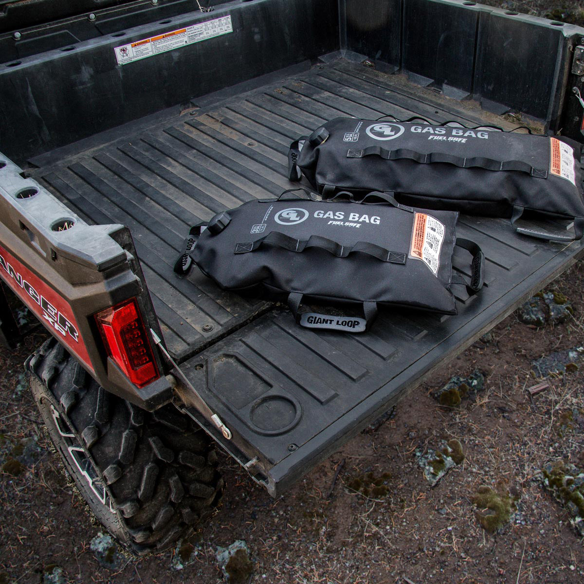 Two Giant Loop Gas Bag Fuel Safe Bladders full, lying on rear of ute